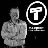 rodric david standing at thunder studios logo